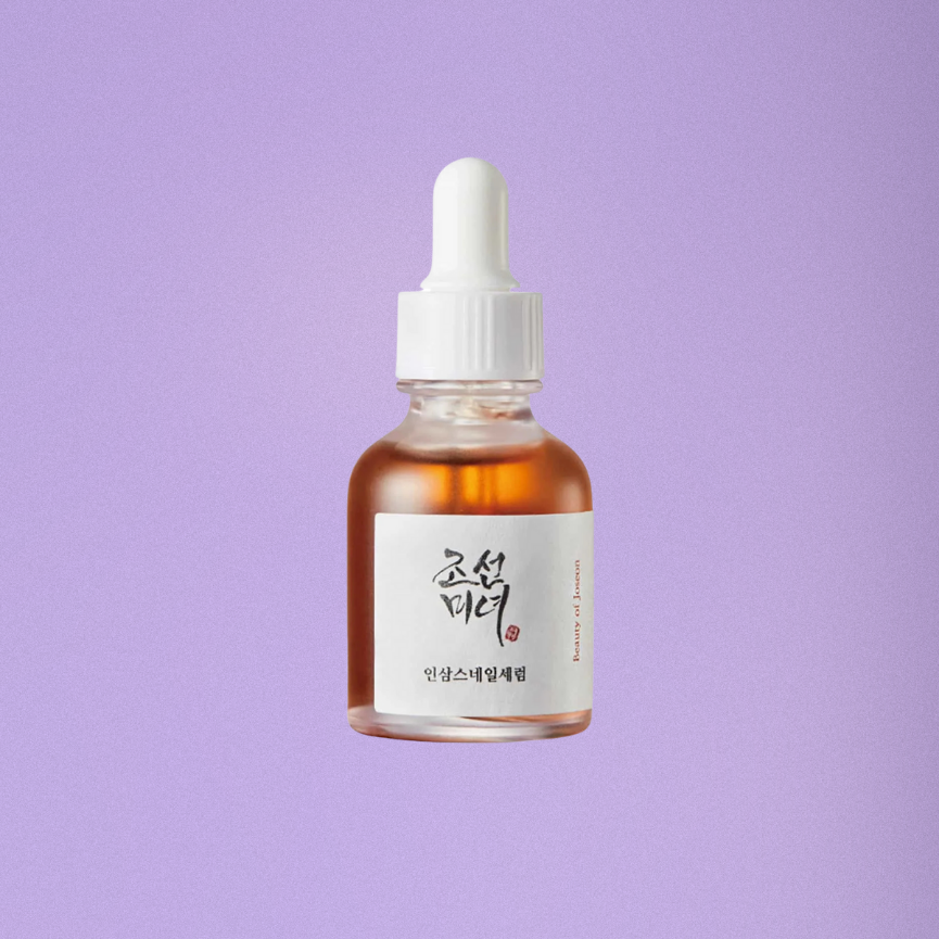 Bottle of skincare serum with a dropper on a purple background